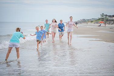 Adorable family on a lifeguard chair in Corolla, North Carolina on vacation in the Outer Banks